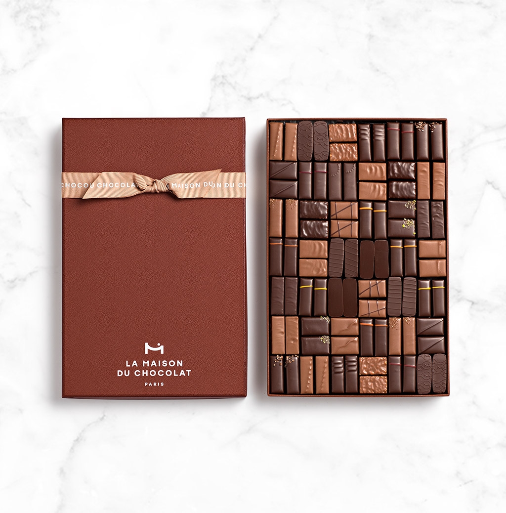 Coffret Maison Noir et Lait 84 chocolats sur fond marbre